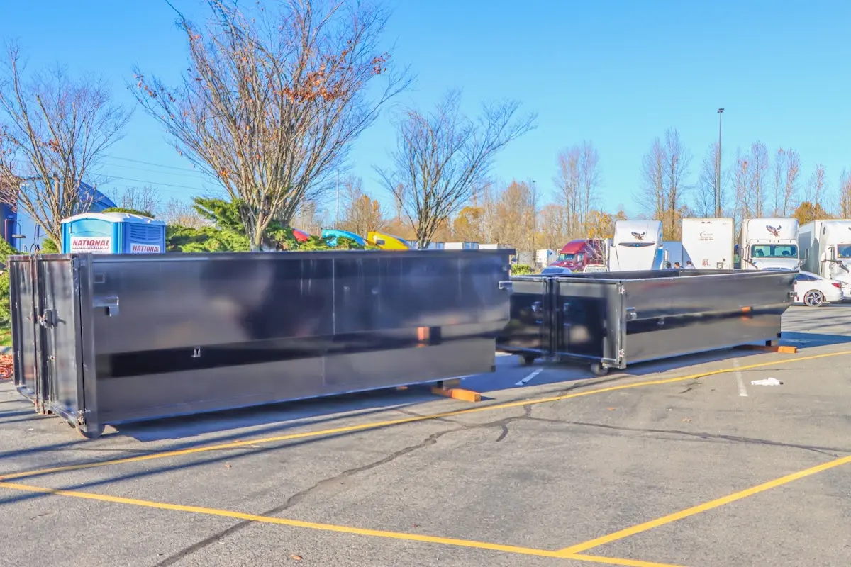 Professional dumpster rental service with roll-off container on residential driveway in Dawsonville